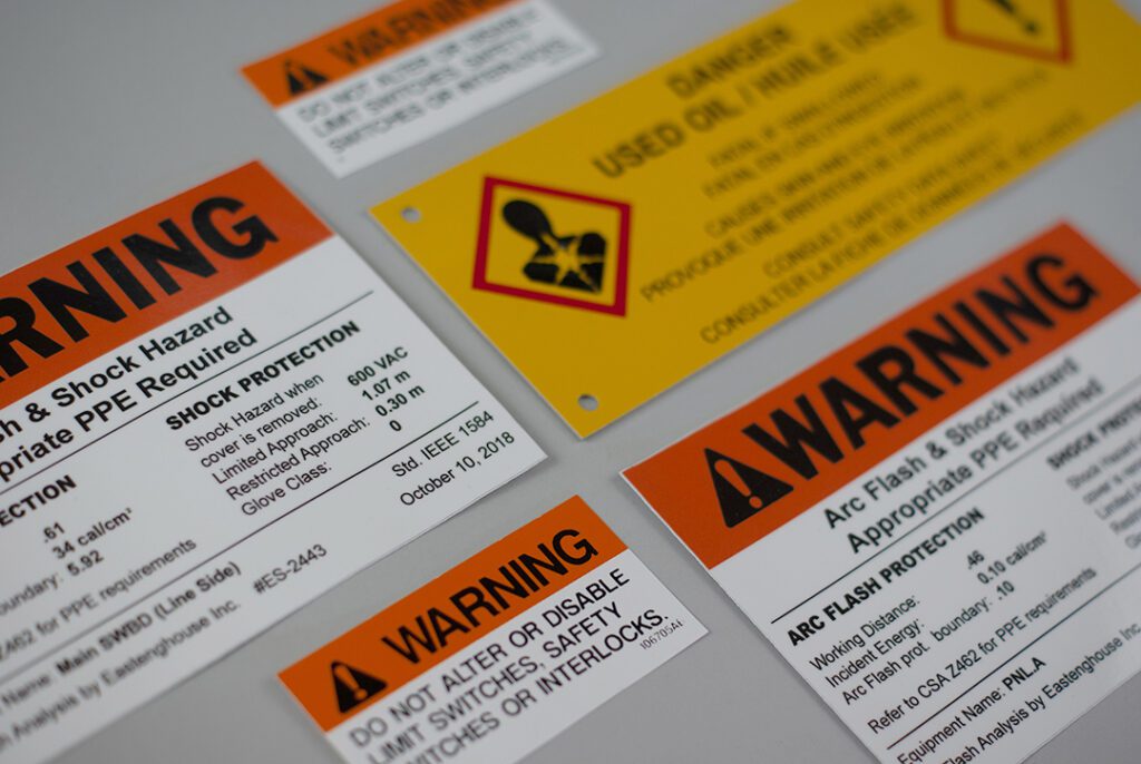 Warning stickers of different Sizes And Colors Are cropped out Against a clean gray background