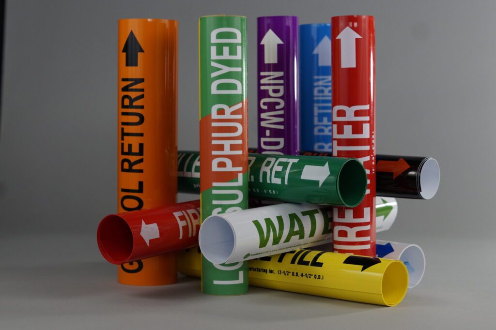 11 colorful coiled pipe markers are crisscrossed vertically and horizontally to create a structure showcasing the different mechanical legends on a clean gray background