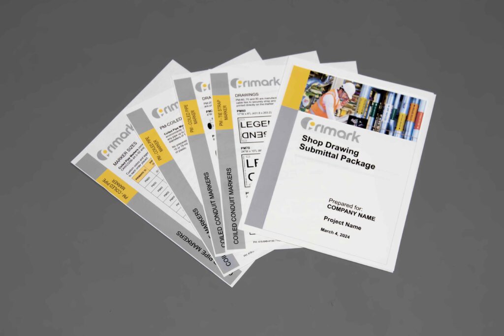 A collection of shop drawing papers on a clean gray floor spread out in an elegant way showcasing diagrams photos and other information