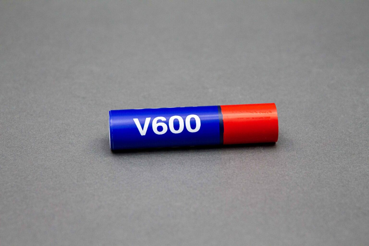 A small blue and red coral conduit marker sits horizontally against a clean gray background. 60% is dark blue with a white legend that reads "v600" the other 40% is bright red