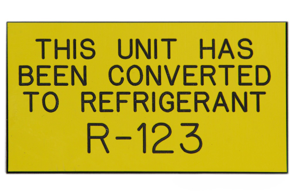 A yellow llamicoid with black text that reads " this unit has been converted to refrigerant R123